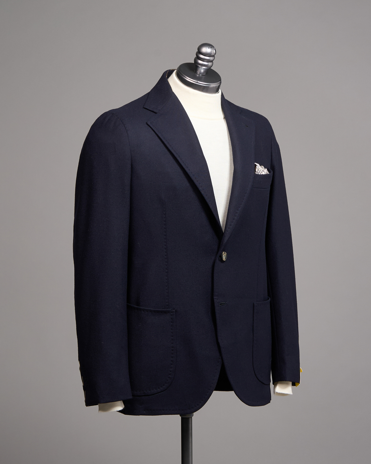 Navy superfine wool blazer from Gabo Napoli, photographed on a tailoring form.